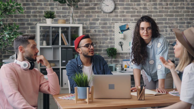 Office workers holding a discussion in a modern workspace