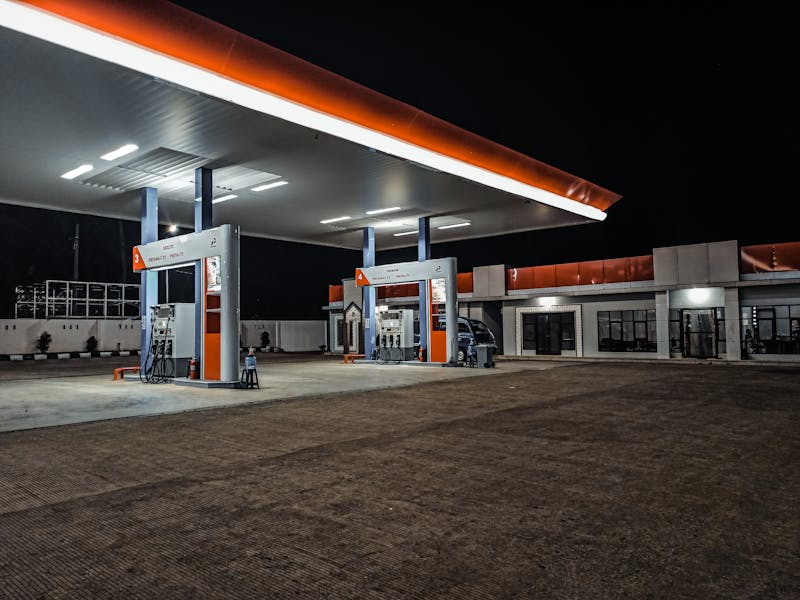 Gas station building with fuel pumps and convenience store at night